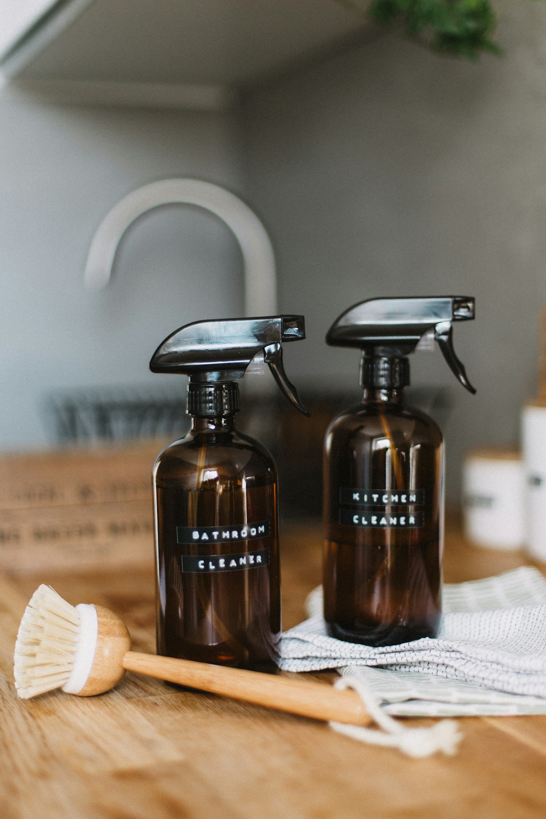 our-story two-brown-spray-bottles-on-brown-table-uoomllxe6ge